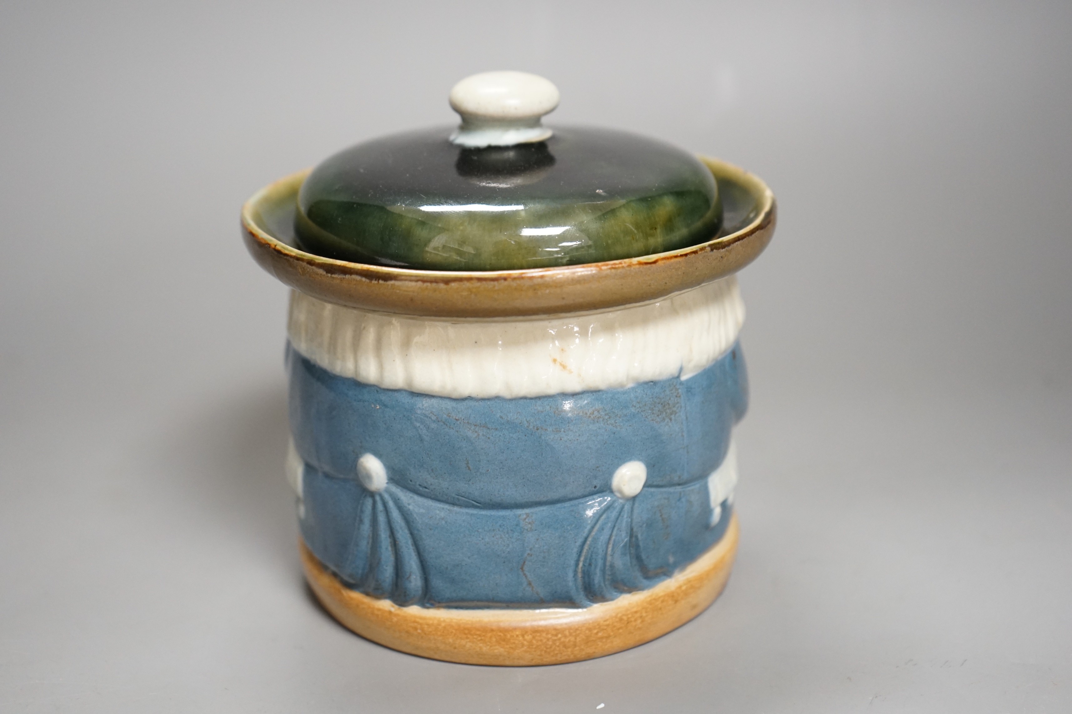 A Doulton Lambeth tobacco jar by Harry Simeon, 13cm